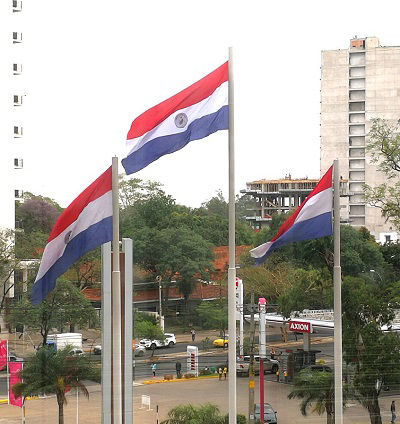 A trio of Paraguay flags fly in Asuncion, Paraguay