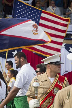 An American Samoa flag flies next to a United States of America flag